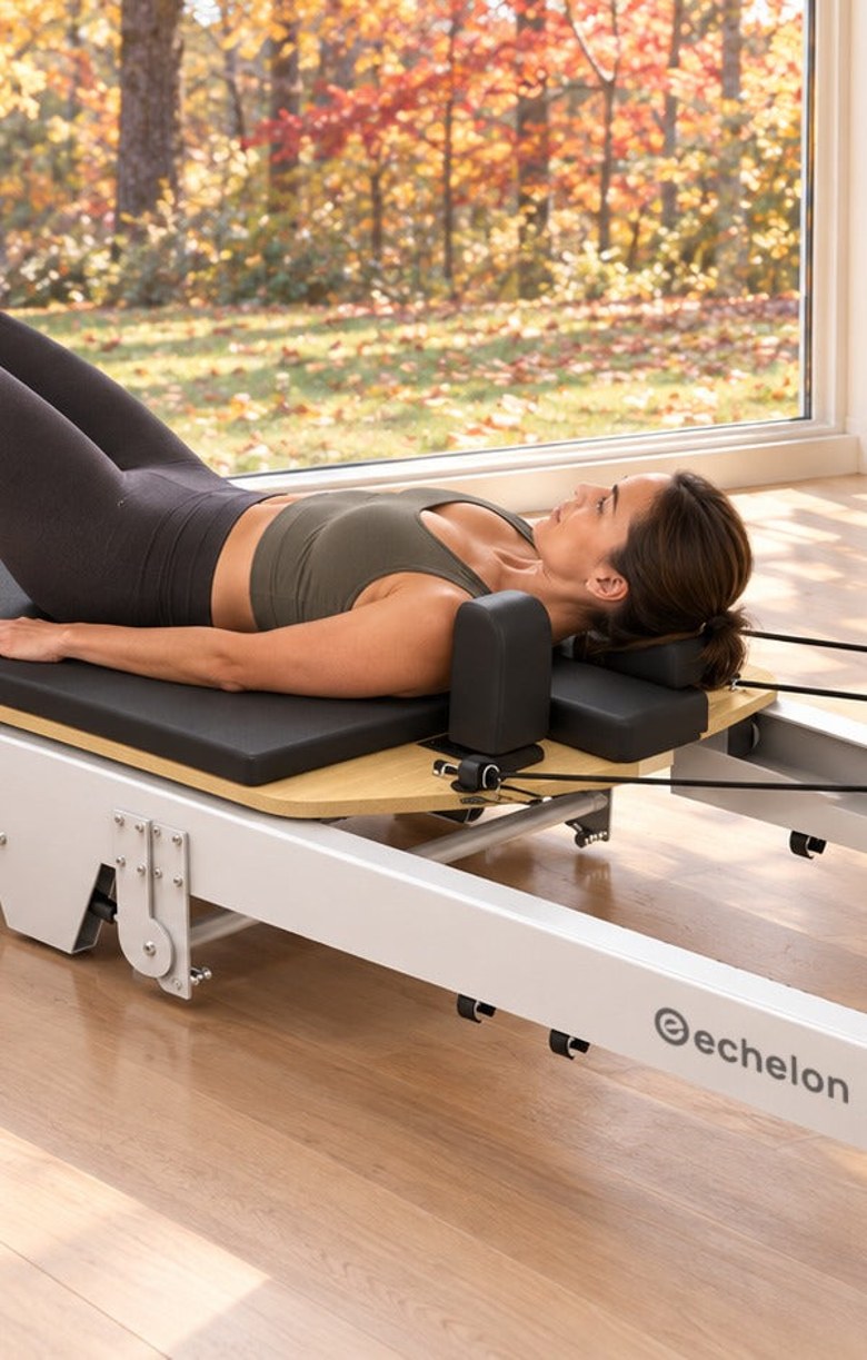 Woman training on the Echelon Meridian Pilates Reformer at home